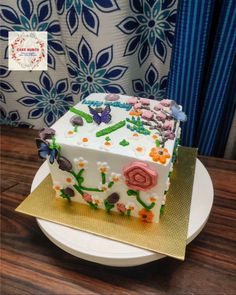 a white cake with flowers and butterflies on it