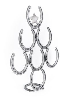 a silver metal sculpture with three horseshoes on it's sides and a star in the middle