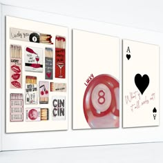 three cards are hanging on the wall next to each other, one has a red object in it