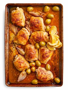 chicken with olives and lemon in a baking dish