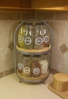 the jars are labeled with different types of spices and seasonings on display in the kitchen