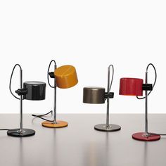 four different colored lamps are sitting on a table