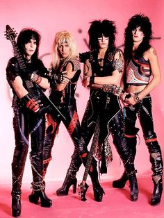 three women dressed in punk clothing posing for a photo with guitars and guitar headsets