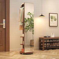 a mirror sitting on top of a wooden floor next to a shelf filled with shoes