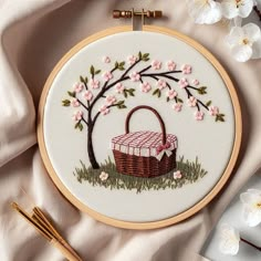 an embroidery project with flowers and a basket