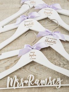 wedding hangers with names and ribbons on wooden boards for the bride and groom to wear