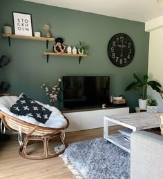 a living room filled with furniture and a flat screen tv mounted on a wall next to a wooden floor