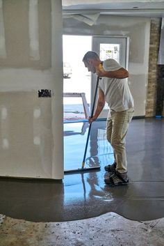 a man is using a mop to clean the floor