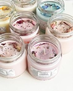 several jars filled with different types of candles