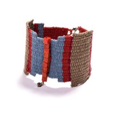 a multicolored knitted bracelet on a white background