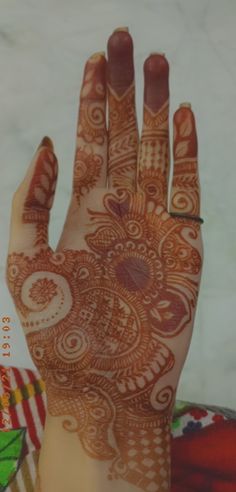 a woman's hand with henna on it