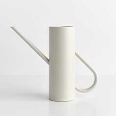 a white watering can with a long handle on the side and a curved tube at the end