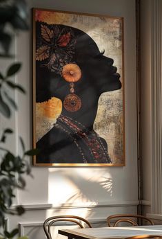 a painting hanging on the wall above a table with chairs and a plant in front of it