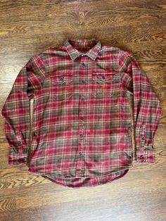 Step into classic style with this beautifully crafted plaid flannel shirt. Featuring a timeless pattern in shades of red and green, this shirt is perfect for any season. Made with high-quality, soft flannel fabric, it ensures both comfort and durability. Details: - Color: Blue, Black Plaid - Material: Soft, Durable Flannel - Closure: Button-up front with matching buttons - Pockets: Two chest pockets with button flaps - Condition: Excellent, gently used - Fit: Regular fit, perfect for layering or wearing on its own Whether you're out for a casual meet-up or a relaxing day at home, this flannel shirt is designed to offer warmth and a bit of vintage charm to your wardrobe. Pair it with jeans or chinos for a complete look. *For measurements please see photos.* Yarn-dyed Plaid Shirt For Fall, Vintage Red Flannel Shirt For Fall, Classic Plaid Flannel Shirt, Yarn-dyed Long Sleeve Plaid Flannel Shirt, Classic Red Flannel Tops, Vintage Red Flannel Shirt, Red Flannel Shirt With Button Closure, Red Flannel Shirt For Fall, Classic Plaid Flannel Shirt For Winter