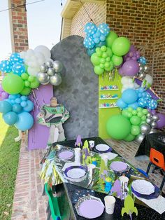 an outdoor party with balloons and decorations