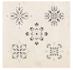 four black and white snowflakes on a beige background