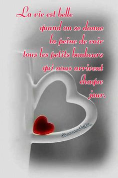 a white cup with a red heart on it and the words la vie est balle quan