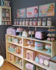 a room with shelves filled with cakes and cupcakes