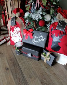 christmas presents sitting on the floor next to a tree