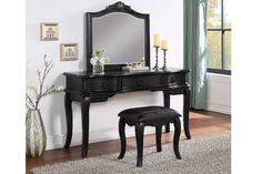 a black dressing table with mirror and stool