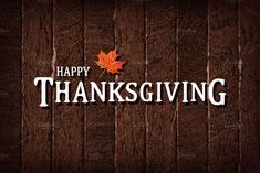 the words happy thanksgiving written in white on a wooden background with an orange maple leaf