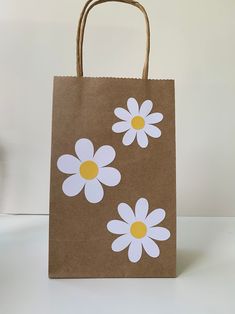 a brown paper bag with white flowers on it