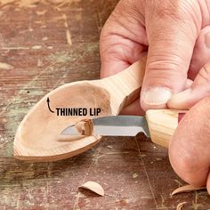 a person using a small wooden tool to cut wood