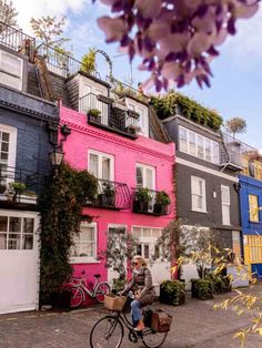 a person riding a bike in front of colorful houses