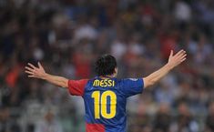 a soccer player with his arms outstretched in front of an audience at a game,