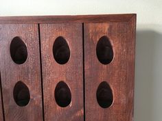 a wooden cabinet with four holes in it