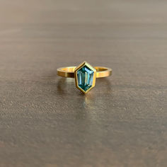 Shimmering sky blues peek from every angle of this bold yet tranquil ring. 

18k, 22k yellow gold 
Zircon, 1.76 carats, 6mm x 8mm Blue Zircon, Gift Card Shop, Crystal Jewelry