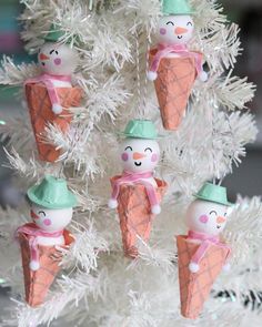 an ornament is hanging from a christmas tree with snowmen and ice cream cones