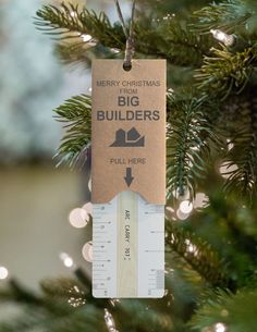 a christmas ornament hanging from a tree with the words merry christmas from big builders on it