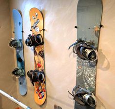 two snowboards mounted to the side of a wall