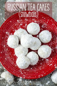 russian tea cakes snowballs on a red plate with powdered sugar sprinkles