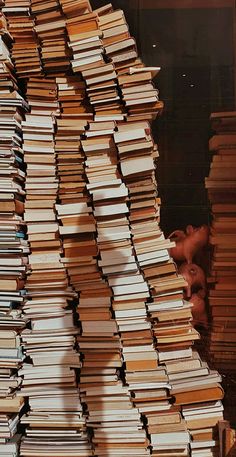 a large stack of books sitting on top of a table