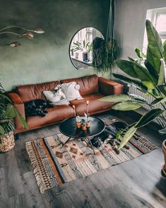 a living room filled with furniture and plants