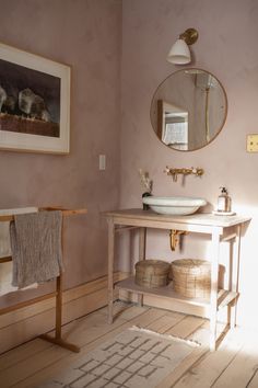 a bathroom with a sink, mirror and rug on the floor in front of it