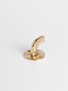 a gold plated metal object on a white background