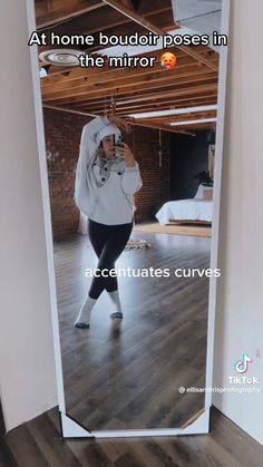 a woman taking a selfie in front of a mirror with the caption at home buddii poses in the mirror