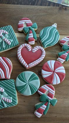 decorated cookies arranged in the shape of hearts and candy canes