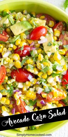 corn salad with avocado and tomatoes in a green bowl