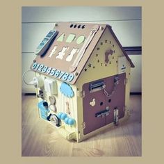 a toy house made to look like it is in the shape of a dollhouse