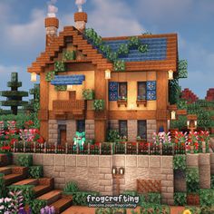 a very nice looking house in the middle of some flowers and plants on the ground