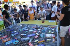 a group of people standing around a table filled with candy