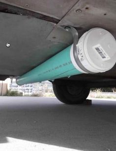 the back end of an airplane with two water cans on it's flat tire