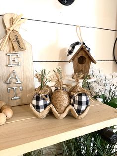 two birdhouses are sitting on top of a shelf next to other items and decorations