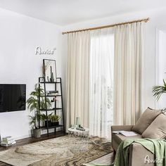 a living room filled with furniture and a flat screen tv on top of a wooden stand