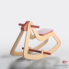 a wooden rocking toy with a pink seat on it's back and red handles