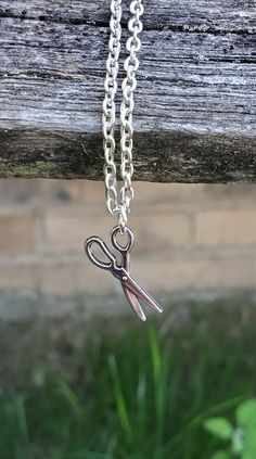 This cute, necklace has a scissors charm and would make a great gift for someone who loves to quilt or sew! The charm and chain are a silver color. The scissors measures 3/4 inch and you can choose the length of the necklace at checkout. This would make a great gift for a birthday, an anniversary, Christmas or any other occasion. All jewelry items come in a gift box. Cute Charm Necklaces For Gifts, Novelty Necklace With Lobster Clasp For Gift, Nickel-free Novelty Charm Necklace For Gift, Handmade Adjustable Charm Necklaces For Birthday, Adjustable Handmade Charm Necklaces For Birthday Gift, Handmade Adjustable Charm Necklace For Birthday, Novelty Pendant Charm Necklace For Gift, Novelty Pendant Charm Necklace As Gift, Novelty Pendant Charm Necklace Gift